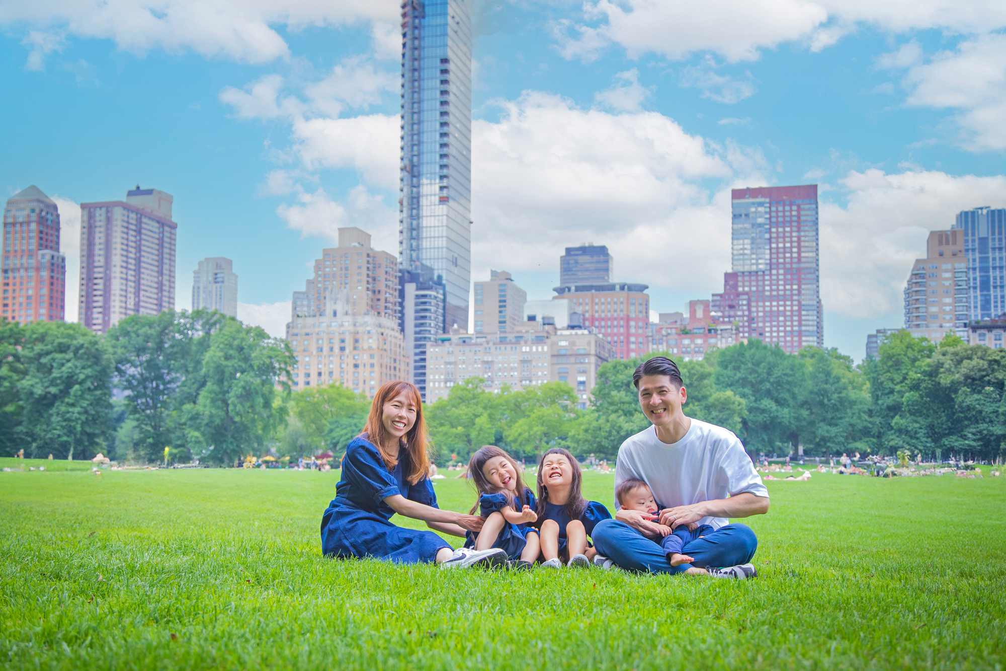 A happy family enjoying a photo session in Central Park, New York, surrounded by greenery and natural light.